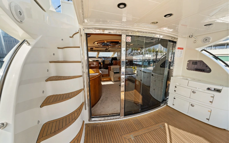 Spacious outdoor deck on the Gulf Craft 60ft yacht with cushioned seating and open-air views – enjoy alfresco luxury with Mala Yachts’ yacht rental in Dubai.