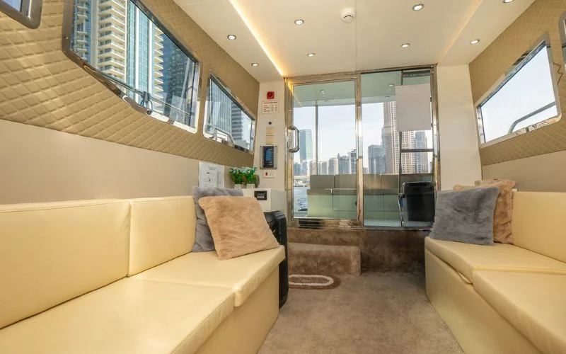 Modern lounge area inside the Riverside yacht featuring sleek furniture and soft lighting – Mala Yachts provides refined yacht rental in Dubai for private comfort.