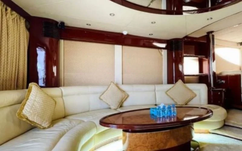 Elegant sofa seating area inside Majesty 70ft yacht with plush cushions and panoramic views – unwind in style with Mala Yachts’ luxury yacht rental in Dubai.