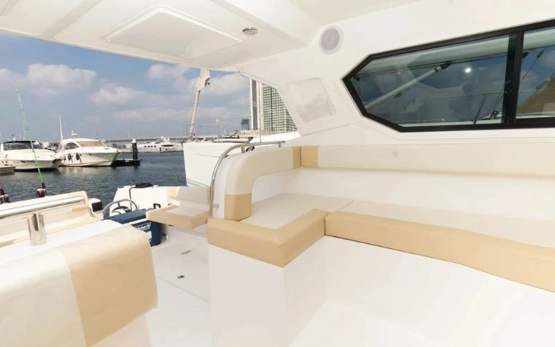 Modern interior of the Storm 36ft yacht featuring sleek seating and polished finishes – Mala Yachts offers premium yacht rental in Dubai.