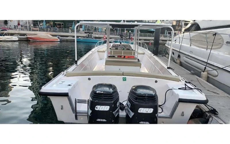 Rear view of a powerful Mala Yachts boat with twin engines, docked in the marina and perfectly maintained for your yacht rental in Dubai.