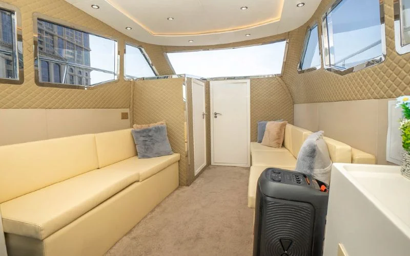 Spacious bedroom onboard the Riverside yacht with plush bedding and ambient decor – Mala Yachts delivers premium overnight yacht rental in Dubai.