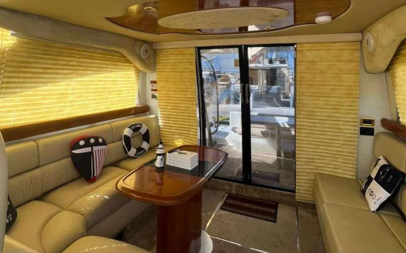 Contemporary lounge inside the Cranchi yacht with leather seating and modern décor – Mala Yachts provides high-end comfort with yacht rental in Dubai.