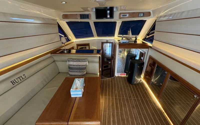 Luxurious interior of Riviera yacht featuring elegant lounge and wood finishes – yacht rental in Dubai by Mala Yachts