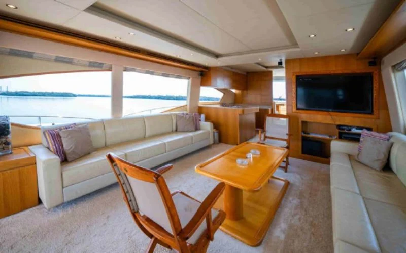 Elegant dining area inside the Kronos yacht with a modern table setup – Mala Yachts offers luxurious yacht rental in Dubai for fine dining at sea.