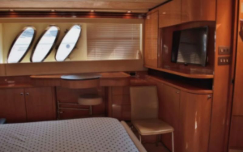 Guest bedroom with cozy lighting and wood finishes on Azimut 81 – Mala Yachts yacht rental in Dubai