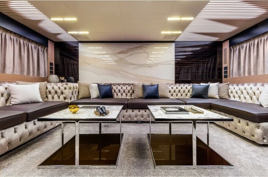 Luxurious salon inside Ferretti 78 yacht with panoramic windows and elegant furnishing – elevate your comfort with Mala Yachts’ yacht rental in Dubai.
