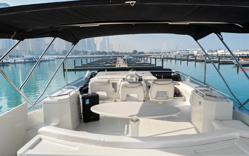 Elegant salon area on the Gulf Craft 60ft yacht with panoramic windows and designer furniture – cruise in class with Mala Yachts’ yacht rental in Dubai.