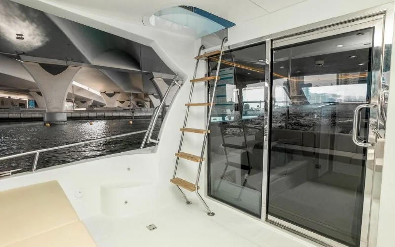 Spacious outdoor deck on the Riverside yacht with plush seating and ocean views – experience open-air relaxation with Mala Yachts’ yacht rental in Dubai.