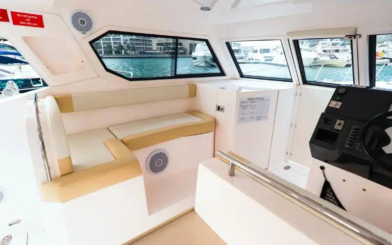 Minimalist interior of the Thunder yacht with neutral colors and cozy layout – enjoy effortless yacht rental in Dubai with Mala Yachts.
