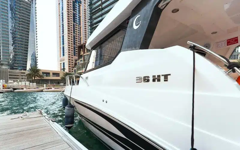 Thunder yacht cruising along the Dubai coastline with skyline in the background – Mala Yachts offers luxurious yacht rental in Dubai for unforgettable moments on the water.