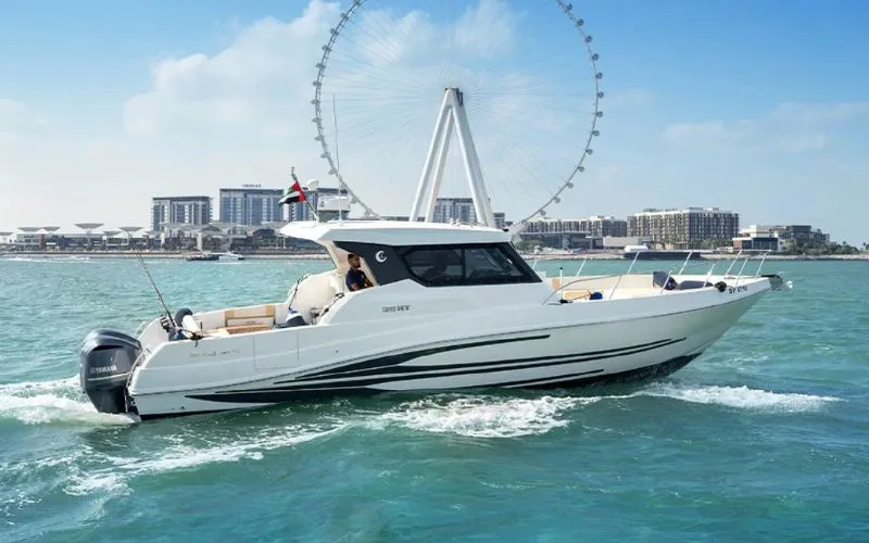 Sleek Storm 36ft yacht cruising through Dubai waters with city skyline in the background – Mala Yachts offers affordable and stylish yacht rental in Dubai.