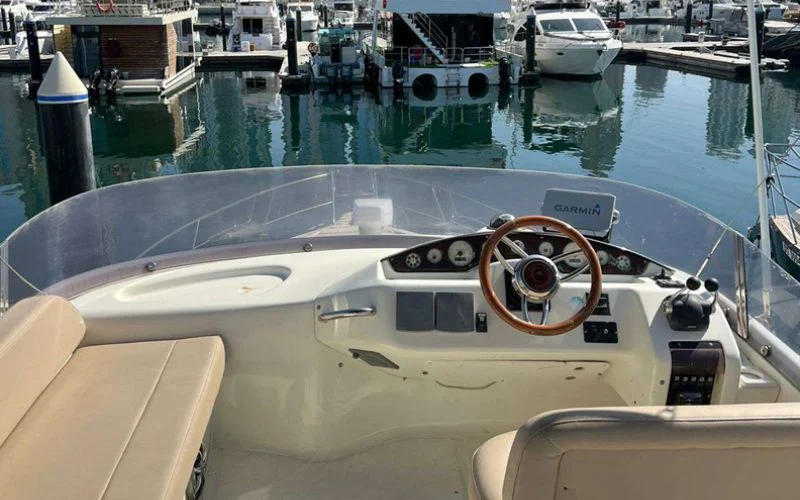 Advanced captain’s helm on the Cranchi yacht featuring state-of-the-art navigation controls and panoramic views – Mala Yachts ensures a smooth and secure yacht rental in Dubai experience.