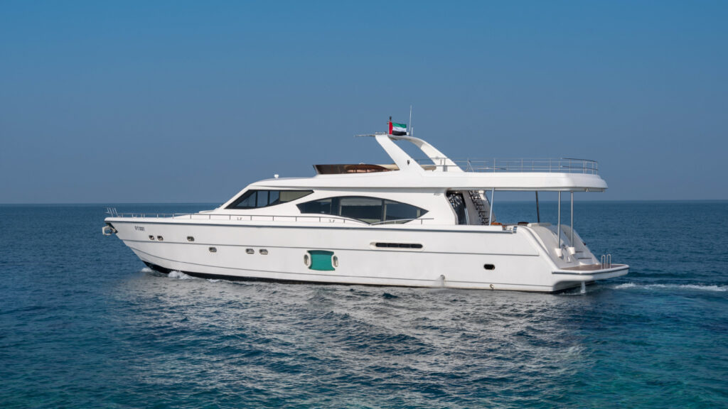 Kronos yacht docked at sunset near Dubai Marina, showcasing sleek design and elegance – experience top-tier yacht rental in Dubai with Mala Yachts.