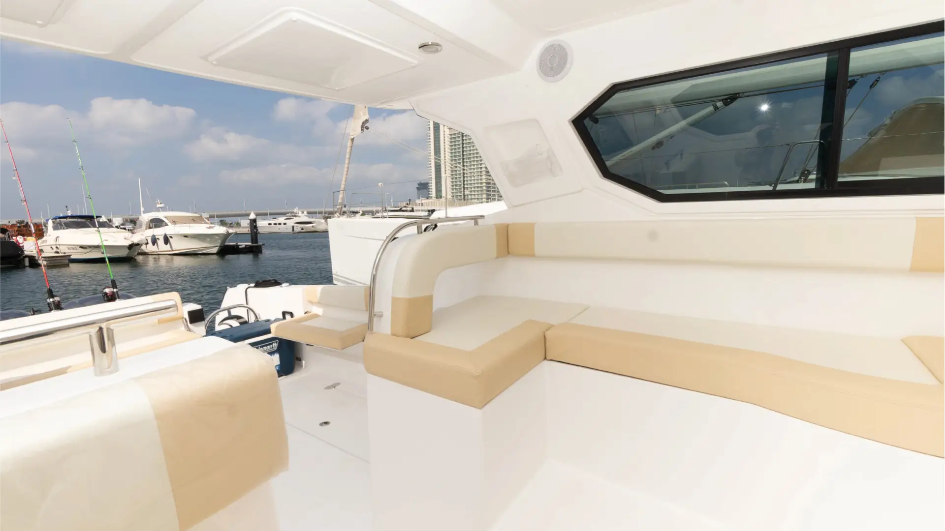 Enjoying the views from the inviting aft deck of the 36ft yacht Dubai, available for charter from Malayachts.ae.