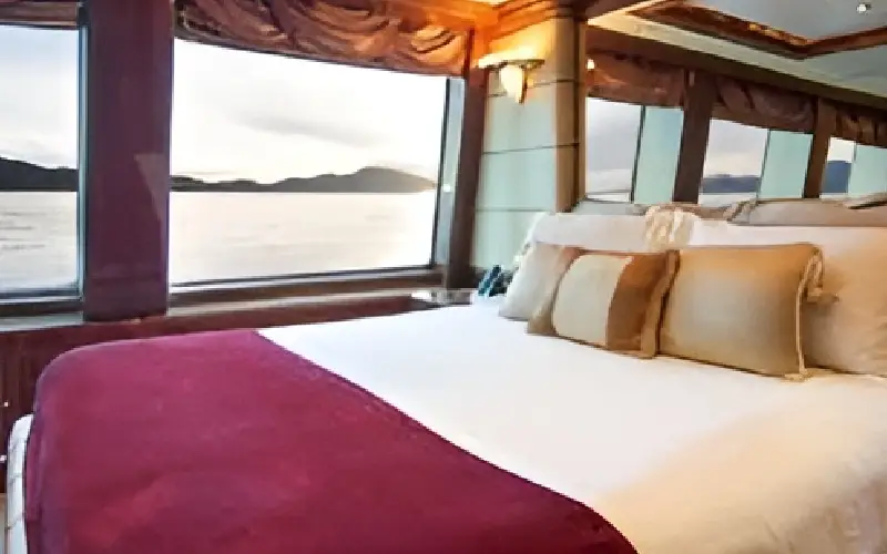 "Comfortable master bedroom in ZAF 70ft yacht – Mala Yachts trusted yacht rental Dubai service"