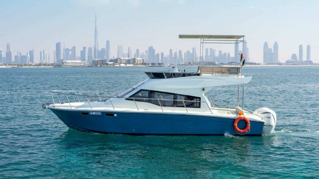 Elegant Riverside yacht docked near the Dubai skyline – experience high-end yacht rental in Dubai with Mala Yachts.