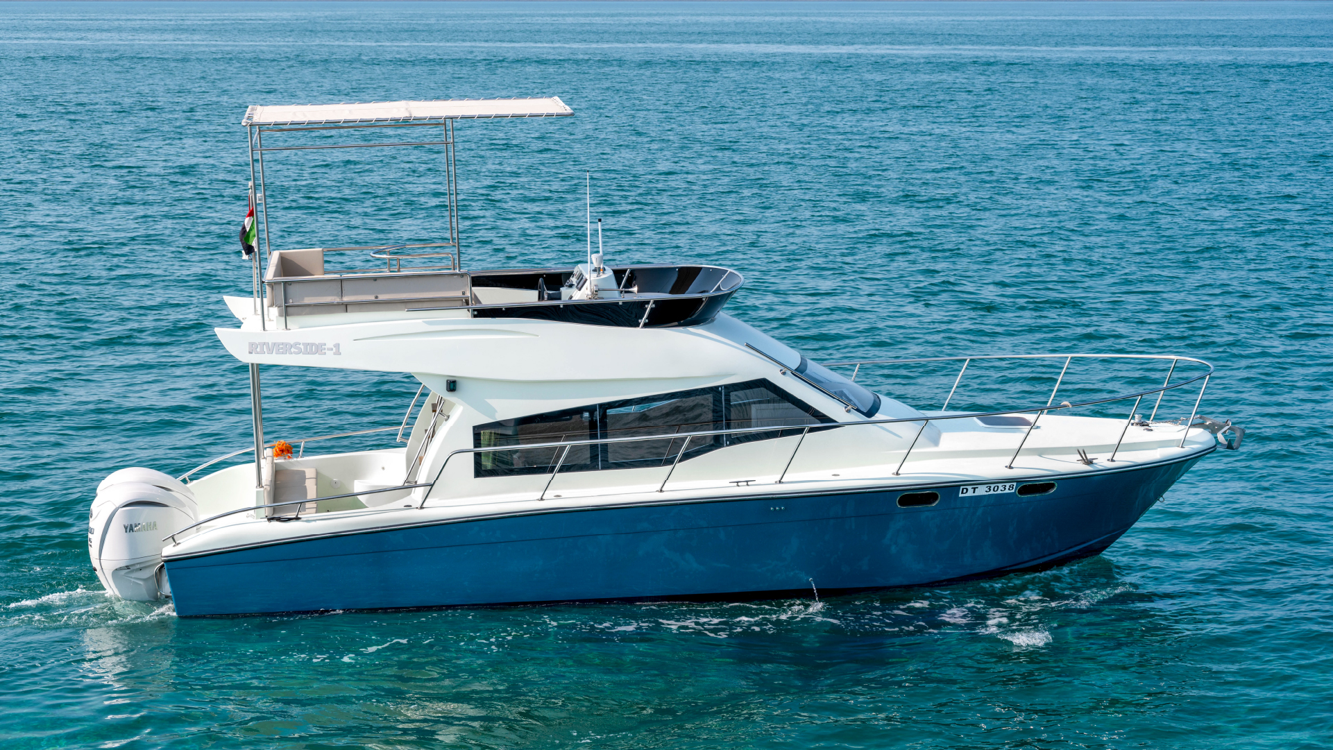 Riverside yacht gliding across the waters of Dubai with the city skyline in the background – Mala Yachts offers first-class yacht rental in Dubai for luxury seekers.