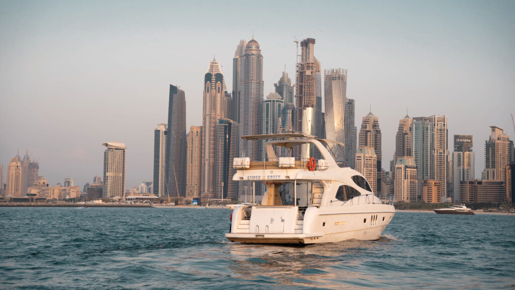 Sleek exterior of the Silver Creek yacht cruising along the Dubai coastline – experience top-tier yacht rental in Dubai with Mala Yachts.