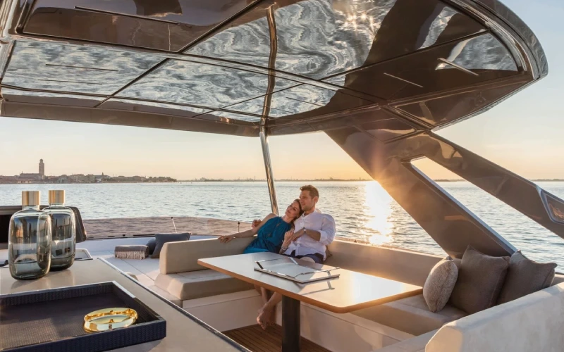 Elegant salon inside the Ferretti 67 yacht featuring plush seating and ambient lighting – indulge in luxury with Mala Yachts’ yacht rental in Dubai.