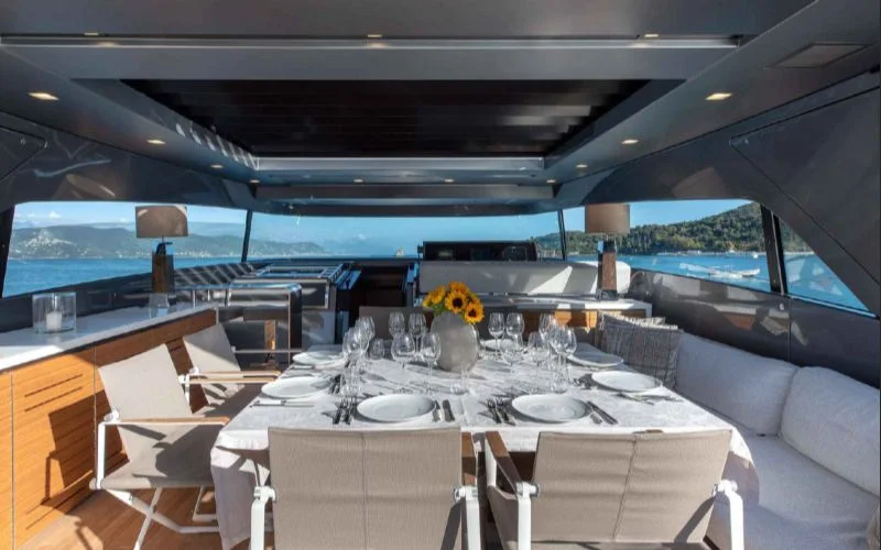 Dine in style on the Tiberias yacht, available through Malayachts.ae, with this sophisticated and open dining area overlooking the sea.