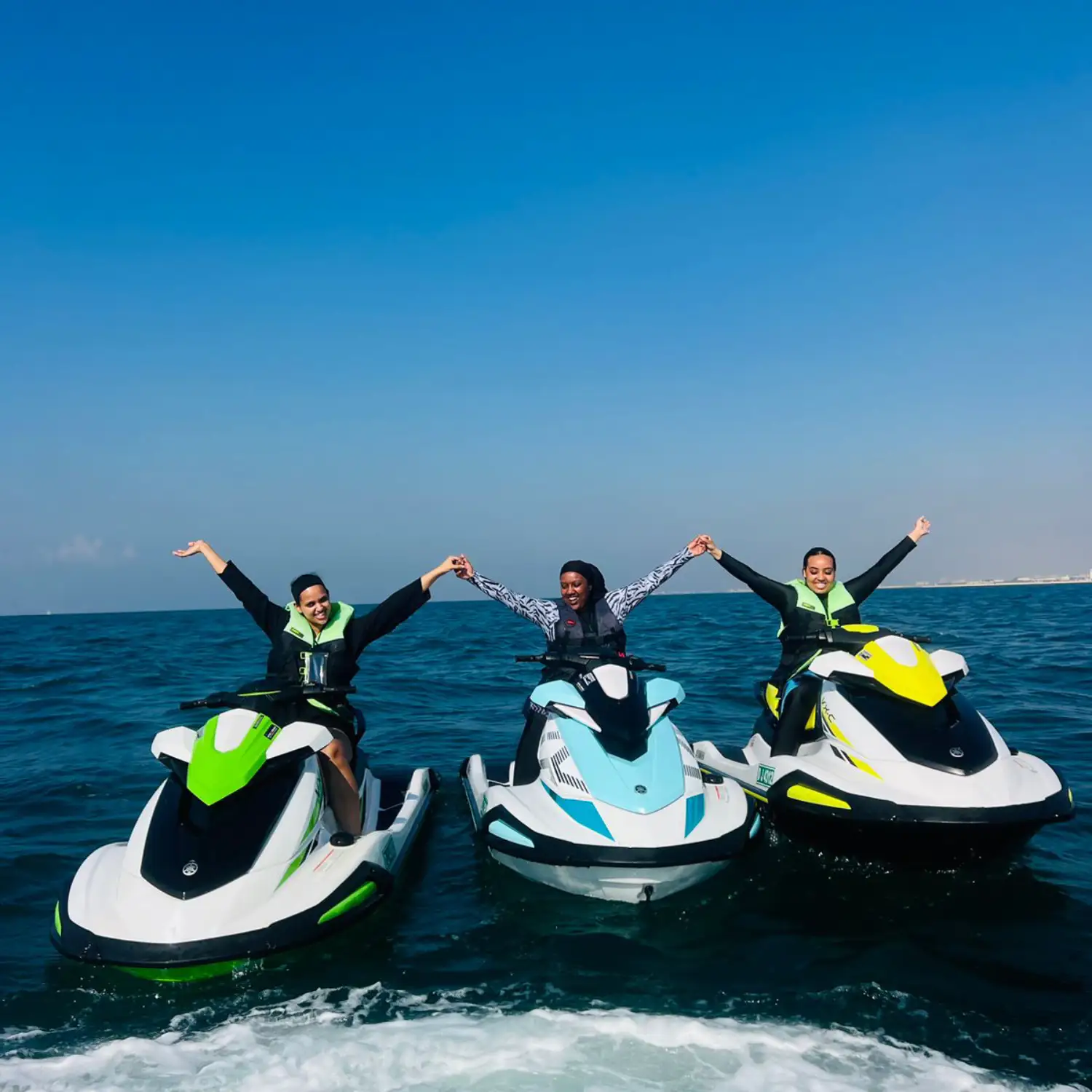 Man performing a sharp turn on a jet ski with Dubai skyline in background