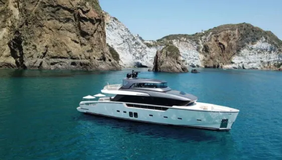 Tiberias yacht docked at Dubai Marina with its elegant exterior and upper deck visible.